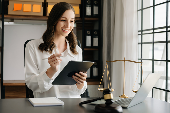 Female lawyer in office using a tablet