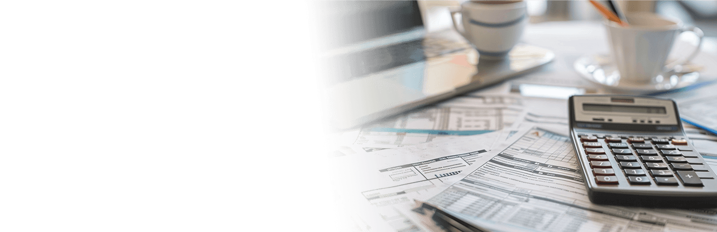 Desk with tax forms, laptop and calculator