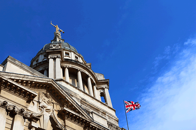 Central Criminal Court building in London with the United Kingdom flag