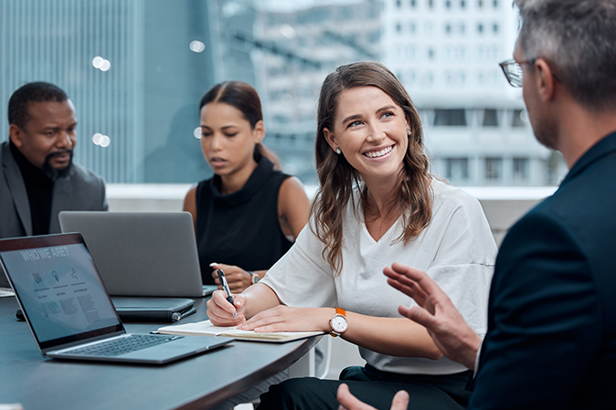Young woman working with colleagues in an office
