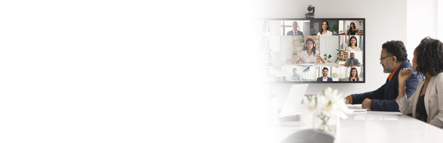 Professionals meeting in a conference room in person and virtually