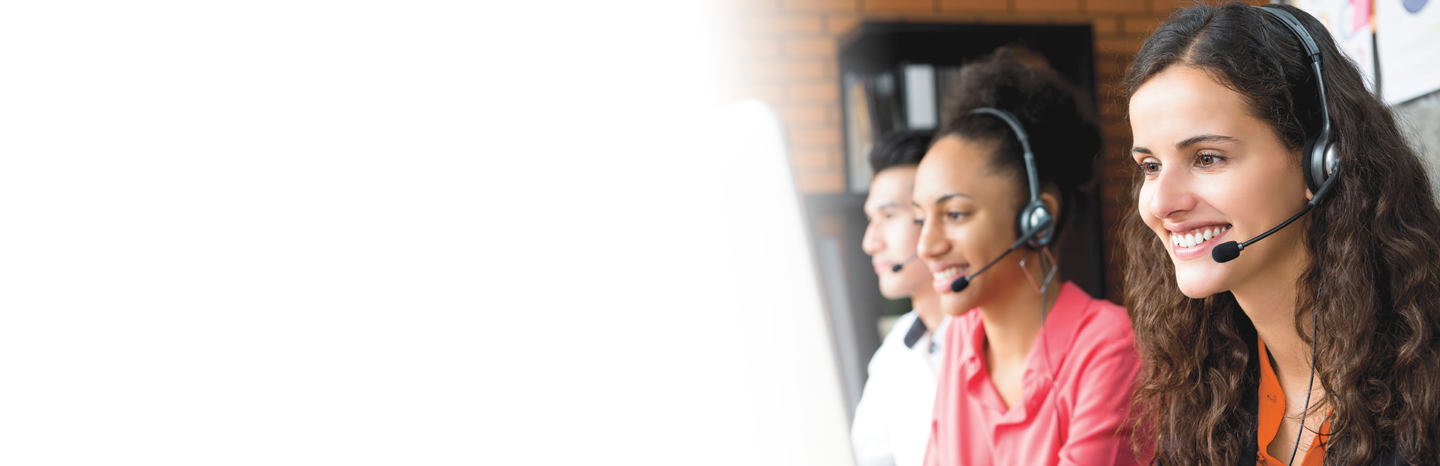 Smiling business woman working in call center with her multi-ethnic colleagues