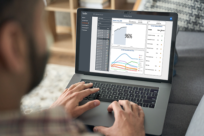 Man on a laptop reviewing a student's analytic results in the Partner Portal