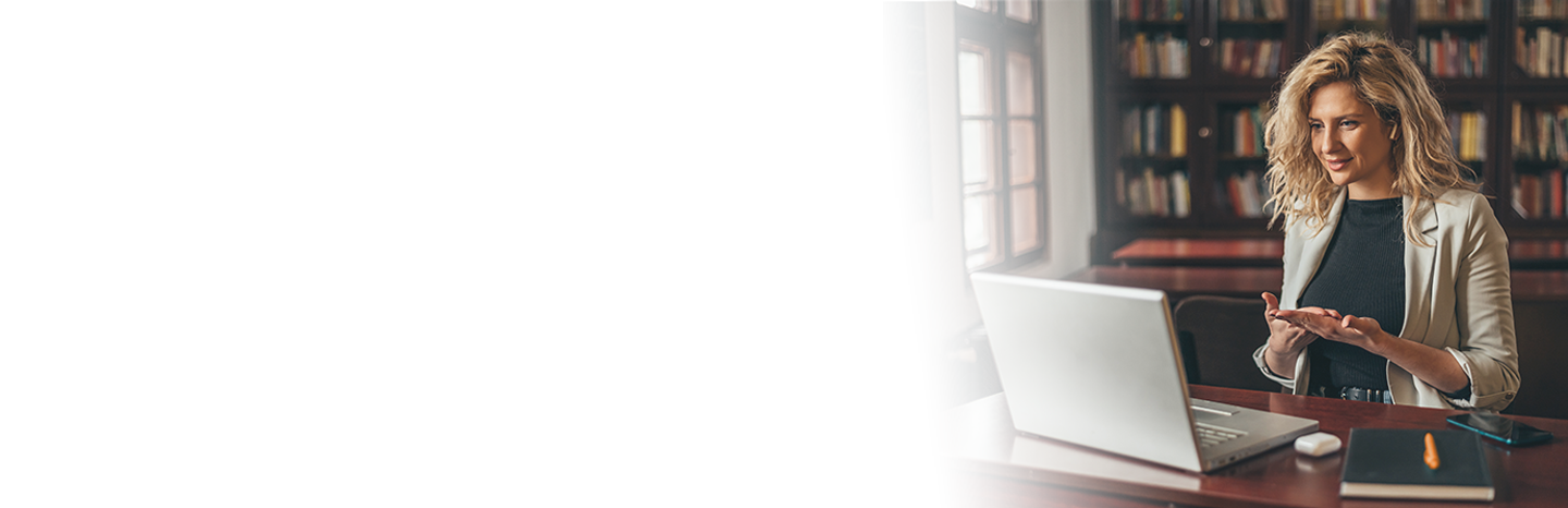 Young woman teaching a lesson on a laptop in a library